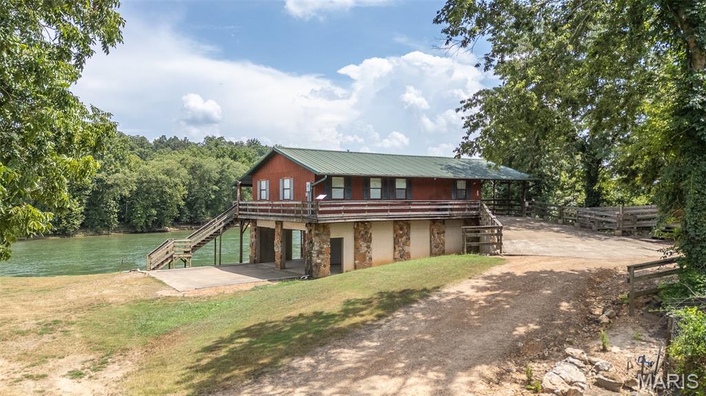 Sitting on a .5 acre +/- lot along the beautiful Current River in Doniphan, this cabin has 2 bedrooms, 2 bathrooms, and stunning river views. Pull right up to the front door, no steps required! Enjoy peaceful mornings or sunset evenings on the spacious walk-around deck. Property also includes a workshop that could be extra living quarters one day! One of the most affordable riverfront options on the market that can be used as a nightly rental or weekend getaway or both!! Don't miss this opportunity!