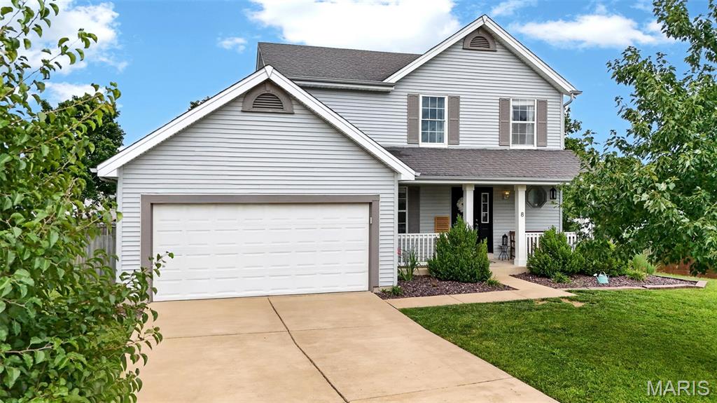 Tucked at the end of a quiet cul-de-sac in O'Fallon's sought-after Kensington Place, this 3-bedroom, 2.5-bath two-story gives you an open, easy-living layout with the kind of updates that let you move right in. A covered front porch and an attached two-car garage greet you at the curb. Inside, the kitchen opens into a sunlit great room anchored by a wood-burning fireplace, so cooking and conversation always stay connected, and it offers granite countertops, stainless steel appliances, a center island, pantry, and a dining area framed by a bright bay window. Ceramic tile and brand-new 2025 luxury vinyl plank flooring runs through the main level, where you will also find convenient main-floor laundry. Upstairs, the primary suite enjoys a soaring vaulted ceiling and a private bath, alongside two additional bedrooms and a full hall bath. The finished lower level adds flexible bonus space for a rec room, playroom, or home office, complete with built-in shelving. Outside, the level fenced backyard offers a wood deck, and mature trees, ready for kids, pets, and weekend gatherings. A new 2026 water heater and  move-in-ready interior complete the picture. Best of all, the home sits in the highly rated Fort Zumwalt School District. Located in the heart of St. Charles County, all of the major highways, grocery stores, shopping, and dining are all just minutes from your front door.