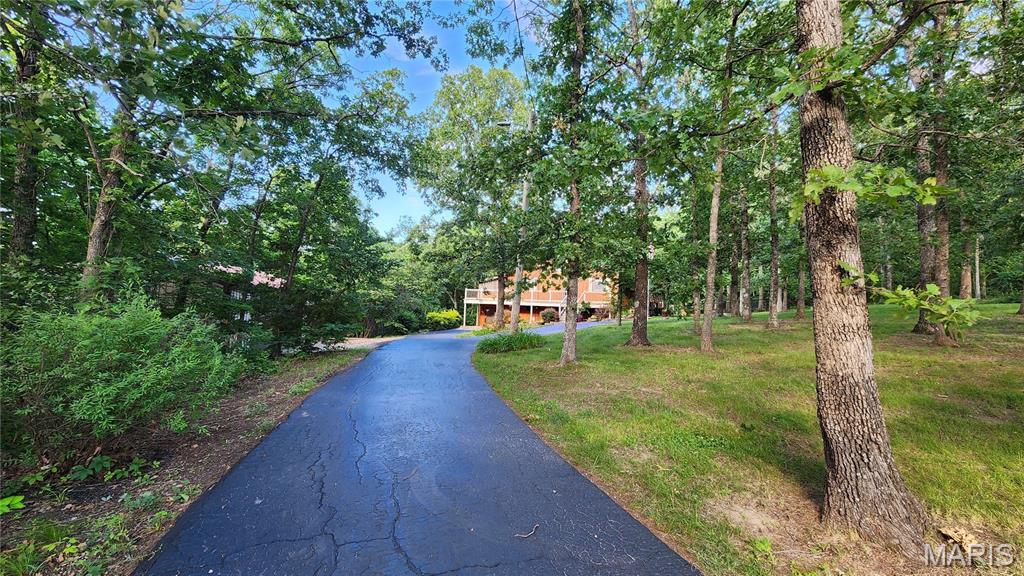 Check out this 3 Bedroom 2 Bath nestled on almost 10 acres of land.  Open living and dining room, screened in porch, nice size Kitchen with large pantry.  Walkout basement to the one car garage and outbuilding that you could fit 3 cars in.  There is also a shed behind that.  Yard is park like setting.