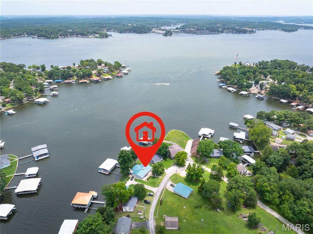 Enjoy 160' of gently sloping lakefront with just 9 easy steps from the 3-slip dock to the spacious screened porch. The dock offers 20 feet of water depth at the slip openings, while the setting provides stunning, layered views from the peaceful cove to the main channel at the 7 Mile Marker of the Osage. Located in a meticulously maintained neighborhood, the HOA offers exceptional amenities including a private water system, boat ramp, boat trailer parking, community gathering areas, and trash service. Designed as a forever home, this property was completely remodeled down to the studs with quality and longevity in mind. A private guest house provides ideal accommodations for family and friends, while the 1,200 sq. ft. tandem 3-car garage includes a climate-controlled workshop. With room to expand living space, add garage or RV parking, or enlarge the dock, this property offers endless possibilities. Bonus-Long term rentals allowed! This ideal property would be perfect for full/part time living as well as allowing you to make additional income. Check out this amazing estate!