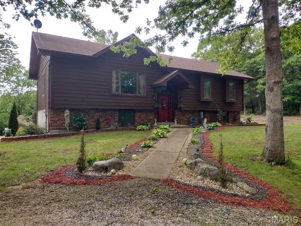 Escape to the peace and privacy of country living in this spacious 4- bedroom, 3-bath split level home nestled on 24+ acres. This home offers an open floor plan, large rooms, vaulted great room, wood Anderson windows and provides plenty of room for family, entertaining, or even just relaxing and enjoying the tranquility of your own private retreat. The 13X15 ft sunroom makes a great place to drink coffee and listen to the wildlife.  The combination of comfort and acreage offers endless possibilities to anyone that wants to raise animals, hunt, garden, or even if your just seeking room to roam. This property has the space to make it happen, all while being within a convenient drive to nearby amenities.