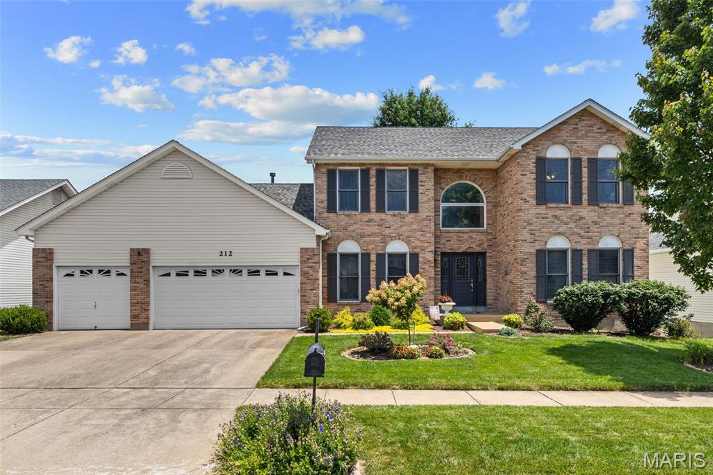 Enjoy exceptional space, beautiful updates, and an incredible backyard setting in this meticulously maintained two-story home located in the sought-after Landings at Lake Chesterfield. From the dramatic two-story entry and expansive main living areas to the spectacular composite deck overlooking the private backyard, every space has been thoughtfully designed for comfortable everyday living and effortless entertaining. An impressive two-story foyer with gleaming hardwood floors, soaring ceilings, and an open staircase creates a memorable first impression. The thoughtfully designed main level balances elegance and functionality with a formal dining room featuring a coffered ceiling and decorative wainscoting, as well as a private home office tucked behind French doors. The expansive family room is the heart of the home, where rich hardwood flooring, a stunning floor-to-ceiling brick wood-burning fireplace, and walls of windows frame peaceful, tree-lined views while filling the space with natural light. Flowing seamlessly into the adjoining breakfast room and kitchen, the open floor plan is ideal for gathering with family and friends. The spacious kitchen offers abundant custom cabinetry, expansive countertops, a custom tile backsplash, stainless steel appliances, a gas oven, walk-in pantry, planning desk, and an oversized center island with generous prep space and seating. Just beyond, the light-filled breakfast room is surrounded by windows and opens through a newer sliding glass door to the expansive composite deck, creating a seamless transition between indoor and outdoor living while showcasing beautiful views of the private backyard. Upstairs, the generously sized primary suite offers a peaceful retreat with a coffered ceiling, large walk-in closet, and an ensuite bath featuring dual vanities, a soaking tub, separate shower, and updated luxury flooring. Three additional bedrooms, each with generous closet space, share a spacious hall bath. The walk-out lower level offers endless possibilities for future expansion and already includes a bathroom rough-in, providing an exceptional opportunity to create additional living space tailored to your needs. Outdoor living is truly a highlight of this home. The composite deck, thoughtfully designed with both covered and open-air spaces, overlooks a beautifully landscaped, level backyard surrounded by mature trees for added privacy. Lush green space, established gardens, a fire pit, and plenty of room to relax, entertain, or play create an outdoor setting that’s as inviting as the home itself. Additional updates include a new roof (2024), composite deck (2020), A three-car garage, and main-floor laundry. Residents of The Landings at Lake Chesterfield enjoy exceptional neighborhood amenities, including a community pool, and playground. Conveniently located in the highly regarded Rockwood School District and just minutes from popular shopping, dining, parks, and major highways, this is a home you do not want to miss!