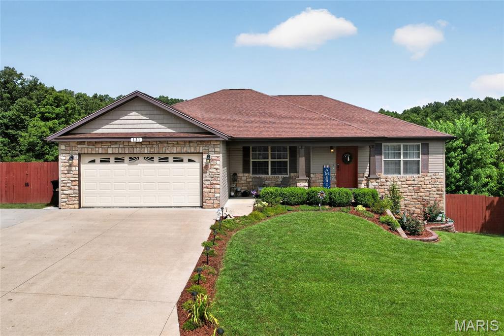 Looking for subdivision living with still a bit of room to call yours? Welcome to 131 Creek View Drive, a home in the Brush Creek subdivision with a custom floorplan made exclusively for these owners when the property was built, along with an oversized lot. Enter through the front door to find hardwood floors in the living room, with vaulted ceiling, leading you to kitchen that you will surely love.  With tiled backsplash, granite counters, new upgraded appliances, filtered water and even pull out drawers for your pots and pans, this space is stylish and well appointed. The kitchen includes a breakfast bar and pantry, as well as easy access to an oversized dining room, giving you plenty of room for a full table and furniture pieces. Primary suite includes tray ceiling, walk-in closet and primary bathroom comes complete with double bowl vanity, tiled shower and separate jetted tub with custom tile surround. One additional bedroom and full bath round out the main floor, along with the laundry room (including washer/dryer and pedestals). Downstairs, a large family room awaits, with custom built-in bookcase.  Two additional bedrooms, full bath and oversized storage area complete the lower level. Both the lower family room and dining room provide access to the fenced backyard. Deck has been newly built, expanded for maximum appeal with all your outdoor furniture needs in mind, and gracefully overlooks the trees. This property includes irrigation system in the front yard, additional parking pad space, manicured landscaping, reverse osmosis and water filtration system.  Located minutes from I-44 and the main gate of Fort Leonard Wood, while still having the privacy of 2.58 +/- acres to call your own, don't let this opportunity slip by!