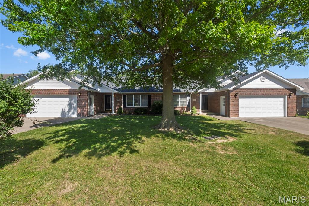 Rare opportunity to purchase an entire brick duplex offering two separate units under one roof — ideal for investors, multigenerational living, owner-occupants, or even friends wanting to purchase together while maintaining independent living spaces. One side offers convenient slab construction with fresh paint and comfortable single-level living, while the other includes a full walkout basement with exceptional storage, workshop potential, future expansion possibilities, and a bathroom rough-in stubbed for a potential third full bath. Both units feature attached 2-car garages, spacious layouts, oversized rooms that feel far larger than expected, and generously sized living areas with vaulted ceilings that create an open, airy feel throughout. Each unit includes a true primary suite complete with a walk-in closet and private full bath, along with oversized secondary bathrooms offering substantial vanity and storage space. Large kitchens with center islands, abundant cabinetry, breakfast areas, and pass-through openings provide both functionality and connection to the main living spaces. Main-level laundry adds everyday convenience in both units. Private outdoor spaces include elevated decks and a covered patio area overlooking a mature, shaded setting beneath established trees. The brick exterior and recent HVAC servicing contribute to peace of mind, while the new roof adds significant long-term value. Whether you're searching for a pure investment property, a way to offset your monthly housing costs, a setup for extended family, or an opportunity to live beside someone you know and trust, this property offers flexibility that traditional single-family homes simply cannot. Did you know owner-occupants may be able to purchase multi-unit properties like this using FHA or VA financing with low or even no down payment, depending on qualification? Live in one unit while using rental income from the other to help support your investment and monthly expenses.