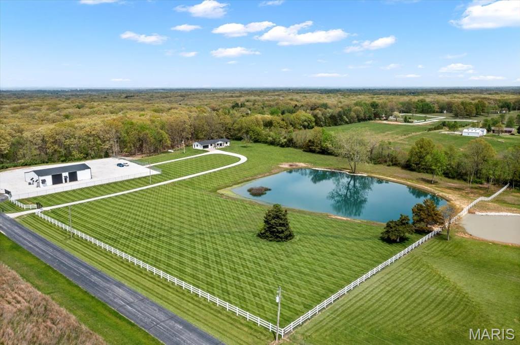 Escape to your own private retreat with this gorgeous 4-bedroom, 3-bath estate, featuring modern upgrades, upscale finishes, and breathtaking views from every angle. This fully renovated, brick ranch offers a bright open floor plan and stylish interior designed for both everyday comfort and high-end living. Nestled on 13.22 acres, the property offers multi-use zoning—.99 acre commercial, 1.1 acre residential, and 11.22 acres agricultural—providing a unique opportunity to live, work, and unwind all in one location. Enjoy stunning countryside views, fishing in your private lake, and abundant wildlife for hunting, right outside your door! A separate gated entrance leads to a premium 70' x 50' outbuilding with two finished office spaces, and a half bath, ideal for a home business or creative space. Enjoy sweeping views of the countryside, one-acre stocked lake, and the peace of a private, wooded backdrop. This exceptional estate offers the perfect balance of luxury and functionality. COOL: 14 SEER+