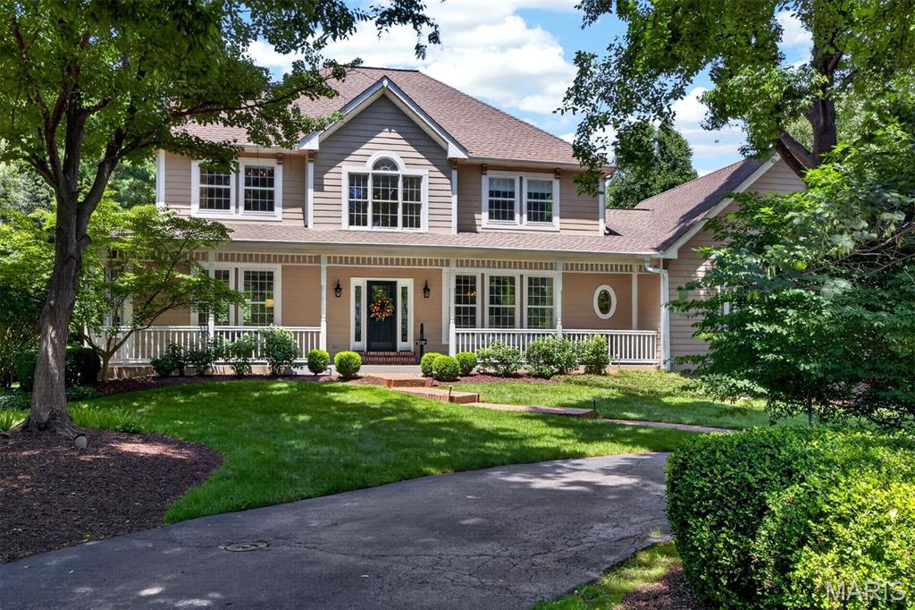Exceptional Colonial with timeless curb appeal, ideally situated on a picturesque 1-acre cul-de-sac lot in the heart of Town and Country. A welcoming covered front porch leads to an impressive two-story foyer, introducing a light-filled center hall floor plan enhanced by rich oak hardwood flooring, extensive millwork, bay windows, and elegant architectural details throughout. The formal living and dining rooms provide refined spaces for entertaining, while the spacious family room features a dramatic floor-to-ceiling brick fireplace flanked by custom built-in bookcases. The gourmet kitchen is appointed with granite countertops, 42-inch cabinetry, and premium stainless-steel appliances, including a Dacor 5-burner gas cooktop, KitchenAid refrigerator, double ovens, dishwasher, and beverage cooler. A generous 6-foot center island anchors the space, while the adjoining breakfast room opens through French doors to a newer deck overlooking the beautifully landscaped grounds. The luxurious primary suite serves as a private retreat with a coffered ceiling, walk-in closet, additional double closet, and a spa-inspired bath featuring a jetted tub. Three additional generously sized bedrooms and a full hall bath complete the upper level. The finished lower level offers exceptional living and entertaining space with a recreation room, game room, and powder room. Outdoor amenities include a spacious deck, patio, sparkling pool, lush gardens, and an expansive fenced yard and an attached 3-car garage, creating a private, resort-like setting ideal for relaxation and entertaining. Recent improvements provide added peace of mind and include Anderson storm windows and replacement kitchen windows (2024), HVAC for upper level (2024), water heater (2026), deck flooring and front railings (2026), gutter guards, and numerous additional enhancements. Combining classic charm with thoughtful updates, this exceptional home offers an outstanding lifestyle opportunity in one of Town and Country's most desirable neighborhoods.