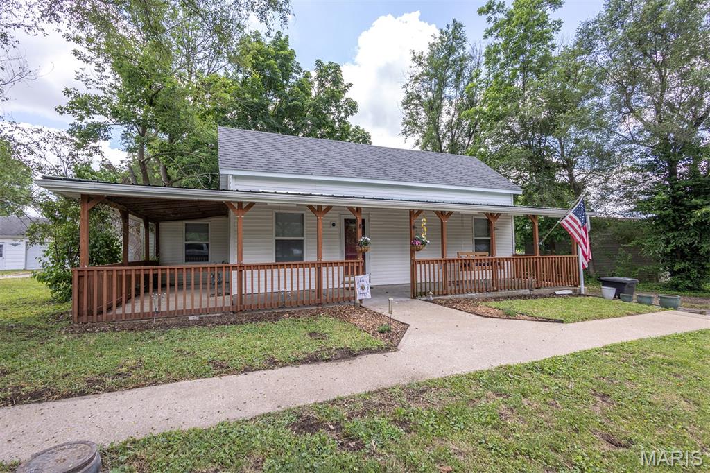This charming 2-bedroom, 1-bath home offers affordable small-town living with plenty of potential. Featuring over 1,100 square feet of living space, this home offers a functional single-level layout and a welcoming covered front porch, perfect for relaxing and enjoying the neighborhood.

Inside, you'll find a spacious kitchen and dining room, plenty of space for everyday living, and the convenience of main-level laundry. The kitchen opens to a large rear deck overlooking the fenced backyard, creating an ideal space for entertaining, outdoor dining, pets, or family gatherings.

Additional features include public water and sewer service, natural gas forced-air heat, and off-street parking. The fenced backyard provides privacy and ample room for outdoor activities, gardening, or simply enjoying the outdoors.

With its practical layout, desirable outdoor space, and affordable price point, this property offers a great opportunity for homeowners and investors alike.