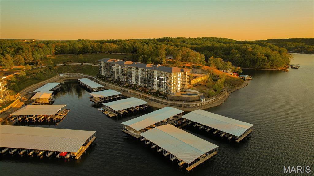 Watch the sunrise over this amazing view from your TURN KEY Monarch Cove investment- recent updates and attention to detail in ownership means you'll have a worry free vacation spot right in the middle of the Lake of the Ozarks action at the 2 mile marker of the Main channel. Cove protection for the docks, these owners UPGRADED to a 12x36 slip for your watercraft, a spot for your Jet Ski or waverunner, multiple pools in the complex- one just down the elevator from your unit on the way to the boat slip which is also extremely conveniently located. Stainless steel appliances, screened patio so you actually enjoy sitting outside, a Jetted tub in the main suite, droolworthy lake views from the entire living space and main suite, this place is just around the corner from so many conveniences, you'll never wanna check out! Extra PWC slip, Garage space, 15k lift and even a boat are available all for extra cash- come plug in here for the ENTIRE lake experience! (NOTE- New couch and murphy bed as well as king size bed in second bedroom, photos coming soon!)