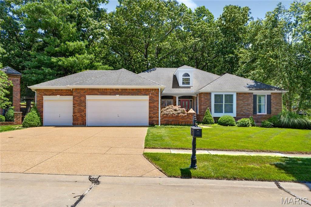Welcome home to this exceptional ranch offering more than 4,000 square feet of beautifully finished living space in the highly sought-after Woodlands at Winding Trails. Meticulously maintained and thoughtfully updated, this home features a stunning kitchen with granite countertops, stainless steel appliances, induction cooktop, and a wet bar with built-in wine racks. The inviting hearth room addition creates the perfect gathering space and is highlighted by a second gas fireplace. Vaulted ceilings and abundant natural light enhance the main living areas, while rich Brazilian cherry hardwood floors add warmth and elegance throughout.

Just off the foyer, a spacious private office offers flexibility and could easily serve as a fifth bedroom. The luxurious primary suite features coffered ceilings and impressive 9-foot sliding doors that open directly to the expansive rear deck.

Designed for both comfort and entertaining, the home is equipped with a surround sound audio/video system serving much of the residence. The finished lower level expands the living space with a fourth bedroom, third full bath, large cedar closet, built-in workspace, and generous unfinished storage areas.

Nestled on a private, professionally landscaped lot, the outdoor setting is equally impressive, featuring a stone walkway, sprinkler system, and a sprawling deck that spans the entire rear of the home. Recent updates include new deck boards in 2025, siding replacement in 2009, and a new driveway in 2016. Residents also enjoy access to neighborhood pool and tennis amenities, making this a rare opportunity to own a beautifully updated home in one of the area's premier communities. Rockwood School District! *ONE YEAR HOME WARRANTY INCLUDED*