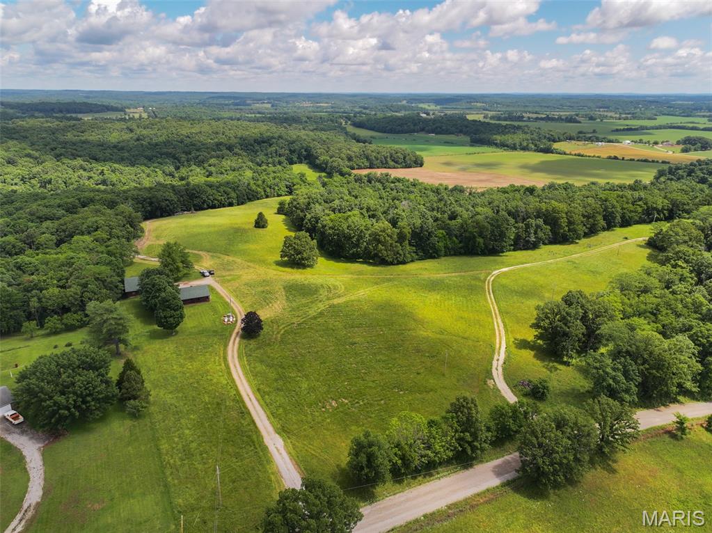 Located in Cape Girardeau County near Whitewater, Missouri, this 101.54 +/- acre recreational property offers a combination of open ground, timber, trail system, and improvements suited for a variety of uses. The property is situated approximately 30 minutes from downtown Cape Girardeau and provides convenient access while maintaining a private rural setting. The land features a mix of open acreage and wooded terrain with a trail system that extends throughout much of the property. The trails provide access for ATVs, utility vehicles, hiking, wildlife observation, and property maintenance. The layout of the land creates opportunities for outdoor recreation, hunting, and exploring different areas of the farm. A 1,320 +/- sqft log cabin is located on the property and includes four bedrooms and two full bathrooms. The cabin can serve as a weekend retreat, hunting cabin, or full-time residence. Nearby, a 35'x40' shop building offers additional storage space for equipment, tools, ATVs, tractors, or recreational gear. Utilities are already established with two separate electric meters on the property. One electric service is connected at the cabin, while the second meter is located at an additional build site, providing flexibility for future improvements or expansion. The combination of open ground and timber creates habitat diversity that supports local wildlife populations and recreational hunting opportunities. The property layout, trail access, and varied terrain provide multiple ways to enjoy the acreage throughout the year.
