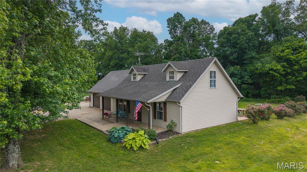 A lot of people dream of a property like this one - away from rules and restrictions, where the stars outshine man-made lights. Not everyone finds it, but you have. This charming home sits on just under 9 acres, at the back of a private lane, and off a county road. Fully fenced with plenty of both open ground and woods, this 1.5 story home has been beautifully updated. Relax on the the covered porch with its view of the woods, then step inside to the living room which opens into an updated eat-in kitchen with gas stove, plenty of cabinetry, seating at the breakfast bar and room for a table. The main level has a bedroom and full bath. Upstairs you'll find a large seating area, bedroom and bath, and another sleeping room with closet and a door to its own deck and stairs. The home has been well-maintained and has a new HVAC system. Outside you'll find a loafing shed and small insulated barn, blackberries, fruit trees and room to garden. The destination is worth the drive to this lovely property. So now that you've found it, don't let it get away!

and has an oversized 2 car garage