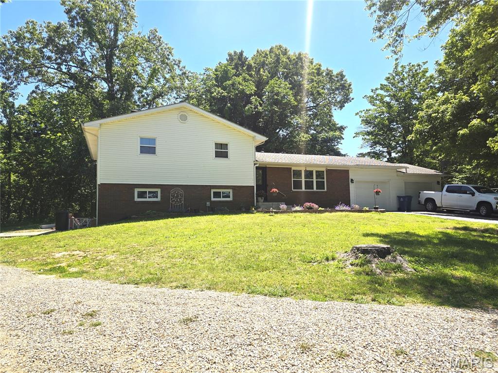 Here is a move-in ready home just for you!  Three bedrooms with the potential to be 4 and 2 full bathrooms.  The living room, dining area, and kitchen are all open and top-notch with an island with storage in the middle.  Stainless kitchen appliances are included.  Step out the back patio doors to a small, fenced area perfect for your private oasis or a great place for children or pets to play.  A split design has three bedrooms and one bathroom upstairs and downstairs you will find a full bathroom, family room, an area to be a 4th bedroom, and a large laundry room with outside access.  A cozy wood-burning fireplace is the focus for this family room!  Another set of patio doors from the family room allow you to enjoy the woods beside the house from the side patio.  Ample storage throughout the home.  The shed can stay or owners will move it.  As you drive up the lane, you'll notice one end of the home has an attached 2-car garage with a concrete driveway and the other side has a gravel drive to the basement entrance at the side patio.  Inside the garage, you will have a door with access to the back yard and 2-separate garage areas with a wall in between them.  Located between Dexter and Bloomfield....it has a Dexter address, but Bloomfield School District!  Don't wait to claim this home as your new address!