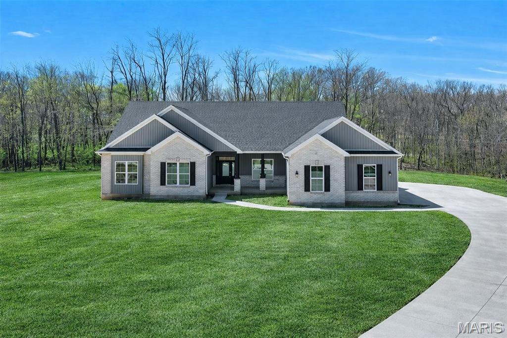 Move-In Ready! SOD COMING SOON!
Welcome to The Dogwood — a striking new 3-bedroom, 2.5-bath ranch home set on 3 private acres at the end of a wooded cul-de-sac in The Estates at Schaper Farms. This beautifully crafted Jaeger Builders home blends refined design with the peaceful acreage lifestyle buyers love.

Offering 2,720 sq ft on the main level, this thoughtfully designed plan features 10-foot ceilings, transom windows, and an open, light-filled layout. The great room flows seamlessly into a stunning kitchen complete with stainless steel appliances, double oven, cabinet hood, microwave drawer, farmhouse sink, soft-close cabinetry, and numerous upgraded finishes already included.

Just off the foyer, a versatile flex room provides the perfect space for a dining area or home office. Step through the slider to a patio overlooking your private, tree-lined lot — ideal for outdoor living and even a future pool if desired.

The walk-out lower level features a nine-foot pour and a rough-in for a future bath, offering excellent potential for additional finished space. Located in the Wentzville School District and conveniently close to highways, restaurants, and shopping.

This home is complete and ready for its new owner — schedule your tour today and experience luxury acreage living at its best. Or join us Fridays 11-5:30 or Saturdays and Sundays 11:00 -2:00 at the OPEN HOUSE and experience this property in person!