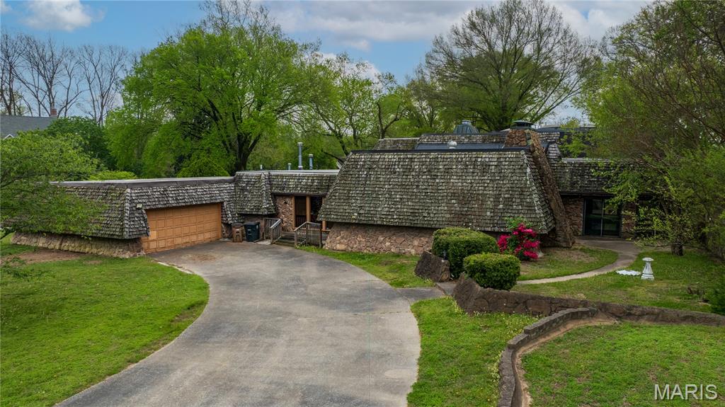 Location + Location + Location! Step into a one-of-a-kind property packed with unending potential and priced below appraisal - offering instant equity from day one - surrounded by million dollar plus homes! Do not let the outside fool you - this is a large home with over 5,000 square feet of living space above-ground. Multiple living room spaces, large kitchen with double ovens and big breakfast area plus a supersized dining room, sunken living room has floor to ceiling stone fireplace. Extra large primary suite with fireplace and large ensuite bathroom - even with a sunken tub! Upstairs are more bedrooms and space - the entire home is perfectly built and laid out encompassing the in-door pool! 4 car garage, 1 acre corner lot, newer roof,  high ceilings and finished basement. If you are tired of the same ole cookie cutter homes this one is for you - it has uniqueness that’s hard to match. This is your chance to customize, design, and transform a truly special space into your dream home. Bring your vision, your dream board inspirations, and your creativity—this property is the perfect canvas.  Right off North Cape Rock drive - Alma Schrader School