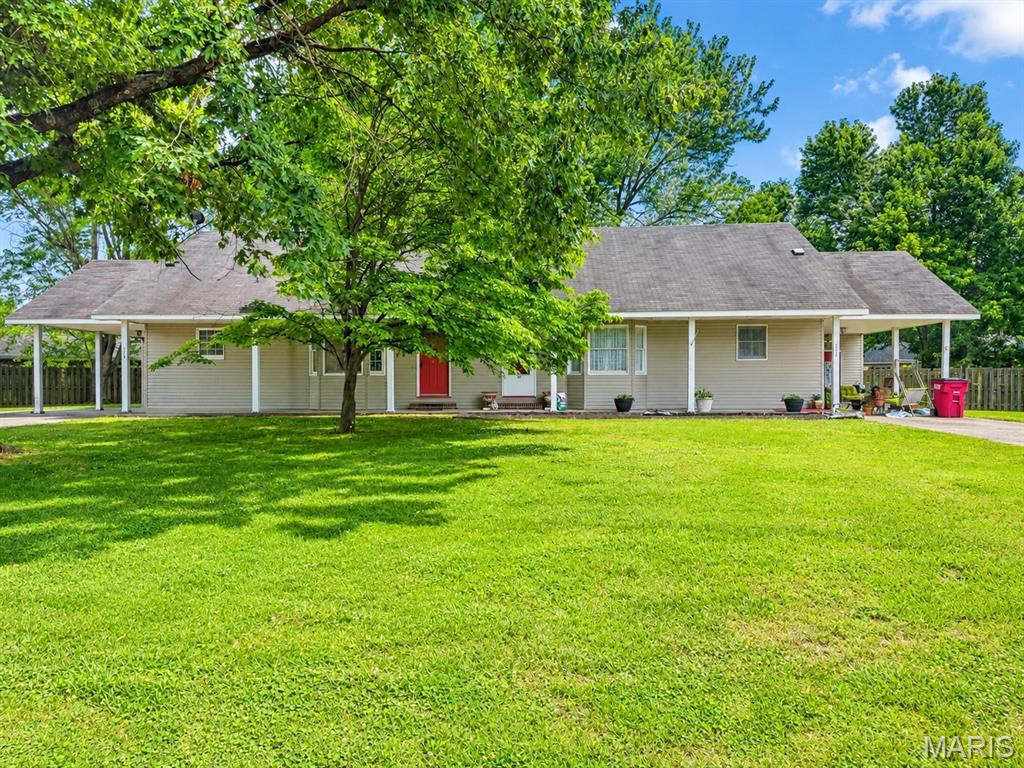 Opportunity comes with this duplex offering versatility for investors or owner-occupants alike! One side is currently rented and features 2 bedrooms, 1 full bath, and an additional flex space just off the kitchen perfect for a dining area, office or extra storage. The second unit offers 1 bedroom, 1 full bath and is full of character with an incredible wooden spiral staircase leading to a lofted space that could be used for an extra bedroom, family room or office. Both units have a wood burning fireplace that add warmth and character. Each unit comes complete with kitchen appliances and each enjoys its own private carport with attached storage area for added convenience. Step outside to a spacious backyard featuring a privacy fence across the back, creating a great setting for relaxing, entertaining or enjoying outdoor space with added seclusion. Whether you are looking to expand your investment portfolio or live in one side while generating rental income from the other, this duplex offers endless potential!