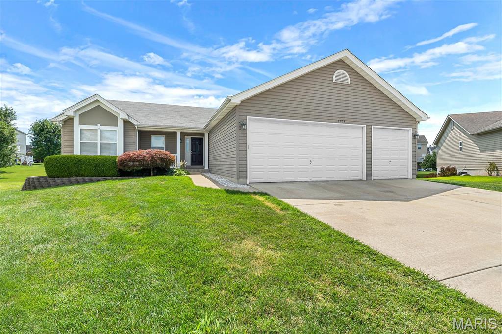 Nestled on a spacious cul-de-sac homesite in a highly desirable Wentzville location, this beautifully maintained ranch offers the perfect blend of style, functionality, and everyday comfort. Set within the acclaimed Liberty School District and backing to peaceful common ground, the property provides a private setting with plenty of room to relax, play, and entertain. One of the home's most exciting highlights is its fresh, move-in-ready appeal. The interior has been recently painted in today's sought-after tones, creating a bright, clean atmosphere throughout. Even better, brand-new carpeting has been installed, giving the next owner the opportunity to enjoy a refreshed home from day one. Inside, an airy floor plan welcomes you with soaring vaulted ceilings and abundant natural light. The central living area serves as the heart of the home, featuring a cozy fireplace and seamless flow into the kitchen and dining spaces. Designed for both convenience and entertainment, the kitchen showcases rich maple cabinetry with crown molding, a decorative tile backsplash, pantry storage, and a raised breakfast bar for casual dining and conversation. The adjoining breakfast room features a charming bay window and opens directly to a large maintenance-free deck overlooking the backyard—an ideal space for morning coffee, outdoor dining, or gathering with friends and family. A thoughtfully designed split-bedroom layout provides added privacy, with the spacious primary retreat tucked away from the secondary bedrooms. This inviting suite features a vaulted ceiling, oversized walk-in closet, and a luxurious bath with dual vanities, and separate shower. Additional features include:  Roof replacement in 2022,  gazebo in the backyard, main-level laundry, an oversized insulated three-car garage with outlet for an EV charger, low-maintenance vinyl siding, and a lookout lower level with rough-in plumbing for a future bathroom and endless expansion possibilities. Situated on a generous lot backing to common ground and conveniently located near shopping, dining, schools, and major commuter routes, this property combines comfort, space, and convenience in one exceptional package!