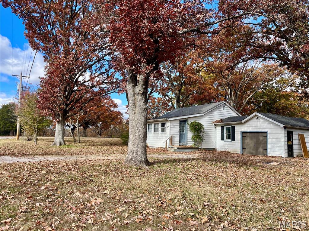Spring is right around the corner—what a perfect time for a new project! This BEAUTIFUL large lot sits right next to the city park and lake. The lot and location are the real showstoppers here. The home is in need of rehab and love, but could be SO worth it for someone who loves this location! The home has about 1145 square feet, with an attached garage. Level, open lot, plus an outbuilding (needs some fixing as well, but is a nice size!), and 2 smaller sheds. ENDLESS possibilities here. If you’re looking for a place where your ideas can take root, this one is worth a look. Home has been winterized. Being sold AS-IS.