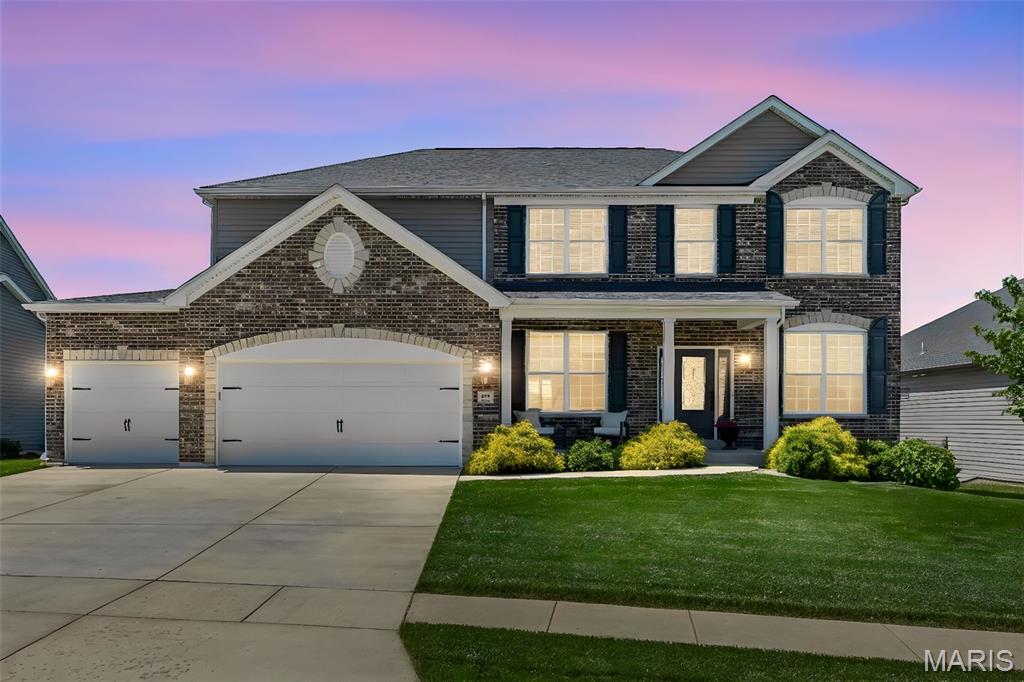 Stunning newer construction home in the highly desirable Lake St. Louis area! Built in 2020, this spacious 4-bedroom, 2.5-bath home offers nearly 3,000 sq ft of thoughtfully designed living space on a generous lot adjacent to a quiet cul-de-sac!
Step inside to discover 9-foot ceilings on the main floor and a dramatic two-story great room featuring a soaring bay window wall, abundant natural light, and an extra-large gas fireplace with blower. The open-concept layout is ideal for both everyday living and entertaining.
The chef’s kitchen is loaded with upgrades including a large quartz island, dual wall ovens, gas cooktop, and an oversized walk-in pantry. Upstairs, the spacious primary suite offers a relaxing retreat with a large walk-in closet, soaking tub, oversized shower, and convenient upper-level laundry room nearby.
Outdoor living is equally impressive with a covered composite deck overlooking the fully fenced backyard complete with in-ground sprinklers and a custom patio featuring a built-in firepit and plenty of room for seating and entertaining.
The oversized 3-car garage includes insulated garage doors (2025), insulated and drywalled walls (2026), added storage shelving (2024), and a NEMA 14-50 receptacle for EV charging installed in 2020. Additional updates and features include backyard fencing (2023), in-ground sprinkler system (2024), buried downspouts and sump outlet with PVC piping and mitered drains (2024), whole-house humidifier (2023), fiber internet connection through Gateway Fiber (2024), and upgraded Toto toilets in all bathrooms.
The unfinished basement offers a rough in bathroom and additional flexible living space for a home gym, rec room, office, or future expansion. Located within the award-winning Wentzville School District with easy access to shopping, dining, parks, and major highways, this move-in-ready home truly checks all the boxes!