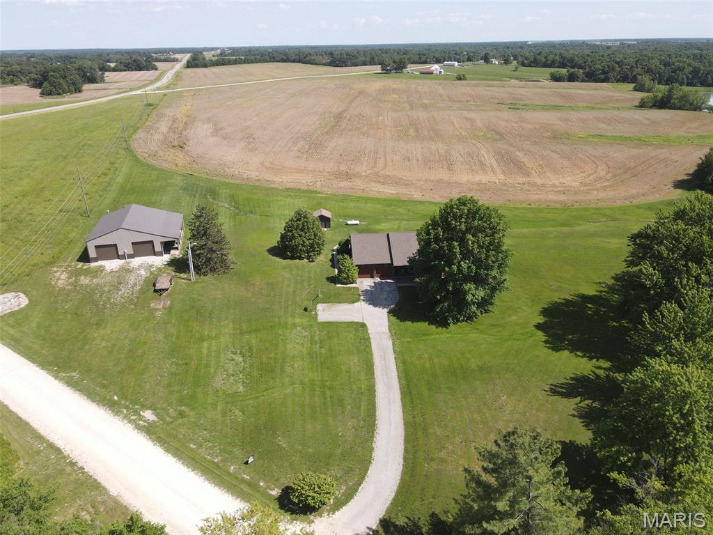 What everyone is looking for: this extremely well-kept brick ranch offers a picturesque setting, prime location & a move-in-ready interior. Featuring an open floor plan, sunny entryway, big rooms, main level master & laundry, full basement, private back patio, and a 40x50 shed - it might be just what you are looking for. Step inside and you'll appreciate the clean interior, spacious living room leading right to the open dining space and kitchen, where there is a pantry, plenty of cabinet/counter space and all appliances convey. You'll appreciate the formal dining space & office area - one of these rooms could also be an additional bedroom if needed. The main level master is a huge room offering his & hers closets, a full bath with double vanity, and a private door leading out to the covered back patio. Two additional bedrooms & bathrooms are on the main level, along with a handy laundry/storage room and a bonus room that could easily be the home office, gym or another bedrooms. Downstairs you'll find plenty of storage, plumbing has been run for a bathroom, and it would not be hard to finish out more of this space for additional bedrooms/living area. This is the perfect time of year to enjoy the shaded & covered front porch and back patio. The 40x50 metal utility shed with 10' overhang was new in 2022 and is heated & insulated with concrete floors, electric throughout, 12x10' tall overhead doors and room for all of your hobbies.

Combine all of these things with the ideal location just off Hwy 6 between Lewistown & Ewing and you have a listing that might not last long.