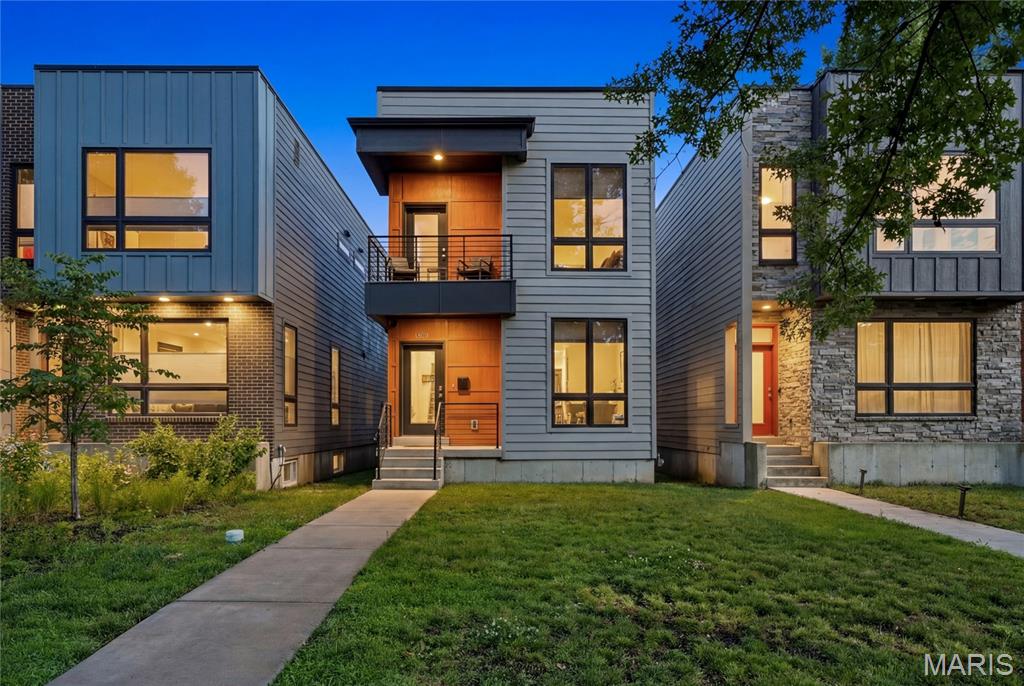 Not your typical St. Louis home — and that's exactly the point! For those seeking something beyond the expected, here's your refreshing departure from the traditional, an architecturally striking newer-construction home perfectly situated in Forest Park Southeast just steps from The Grove. Clean lines, dramatic black-framed windows, and a covered upper-level terrace create a sophisticated streetscape presence that is both unique and functional. The sleek facade and warm wood accents create unforgettable curb appeal, while the contemporary aesthetic carries seamlessly throughout the home. As soon as you enter, the expansive main level's living space is breathtaking! With 9-foot ceilings throughout, the open-concept floor plan is anchored by a gorgeous center-island and rich warm cabinetry, creating a central gathering area while offering flexibility to tailor the front and rear living spaces to your lifestyle. There’s an abundance of space, natural light, and possibilities to create the layout of your dreams. The thoughtfully designed open staircases to both the upper and lower levels add architectural interest while allowing sight-lines to extend from floor to floor, creating a sense of volume and connectivity, enhancing the airy, open feel. The main level also has a half bathroom and easy access to the fenced-in backyard and 2-car carport, but you may just be biking or walking everywhere since the home is perfectly situated off Tower Grove near your favorite restaurants, shops, parks, and the Botanical Gardens! Not to mention it’s just minutes from the BJC/WashU or SLU medical campus by bike. The second level has a huge primary suite with double closets, a spacious floor-to-ceiling tiled shower, clerestory window, double vanity, and your own private covered terrace! Plus two additional bedrooms, a full hall bathroom w/ tub, and second-floor laundry - everyone's favorite! Don’t forget to make your way down to the lower level! It doesn’t feel like a basement, with 9-foot ceilings, lots of light, and an egress window — the possibilities are endless! All the thoughtfully curated finishes create a sophisticated aesthetic in one of the area's most dynamic neighborhoods, known for its thriving restaurant scene, modern homes, and convenient lifestyle amenities within walking distance. This is modern St. Louis living at its best!