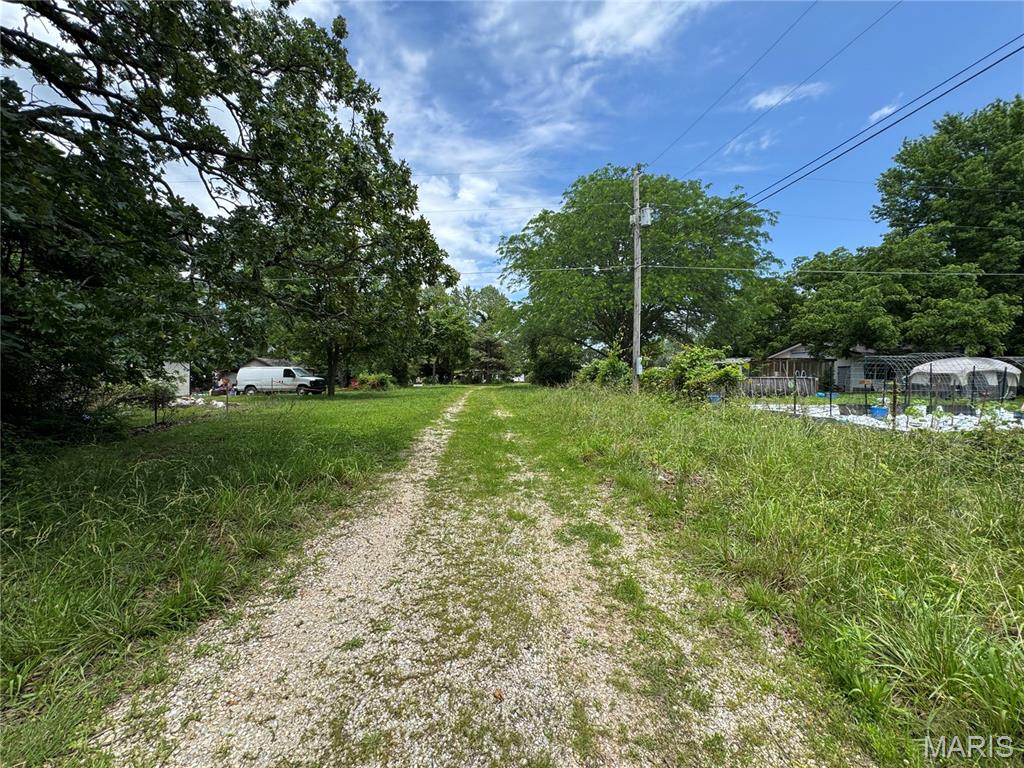 Tucked away at the end of an extended driveway, this 2.27 +/- acre property offers seclusion and privacy. This property includes 2 electric meters and 1 water meter & public sewer connection - all utilities are already in place. Multiple existing mobile homes & scattered debris is located on the property and is being conveyed with no assigned value. Buyers & buyers agents are encouraged to perform their own due diligence regarding the condition and suitability of all improvements, utilities, zoning, lot boundaries & subdivision restrictions if any. Conveniently located near Waynesville MO and ready for your vision to take shape.