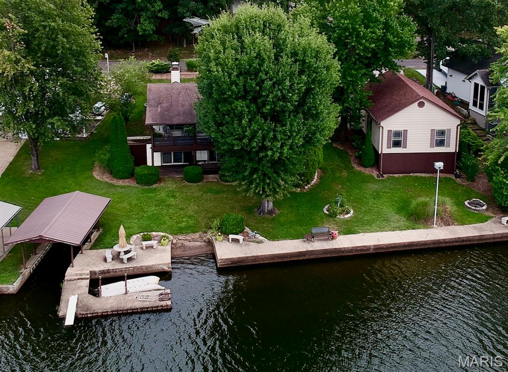 Welcome to lake life at its finest! Rarely does a property like this come available in the highly sought-after community of Peaceful Valley Lake. Situated on a prime, level waterfront lot—some of the most desirable real estate on the lake—this beautifully positioned property offers the perfect blend of recreation, relaxation, and everyday comfort.

This spacious 4-bedroom, 2-bath waterfront home features room for family and guests, a 1-car attached garage, plus an oversized detached garage with abundant space for lake toys, workshop needs, golf carts, ATVs, or extra storage. Step outside and experience what truly makes this property exceptional: an amazing, easy-access lakefront lot designed for enjoying every moment on the water.  All guest bedrooms have a private, glassed, entrance and amazing views of the lake.

Whether you're fishing at sunrise, cruising the lake at sunset, or entertaining friends and family all weekend long, this property delivers the lifestyle buyers dream about.

And the amenities? Peaceful Valley Lake is more than a neighborhood—it’s a destination. Enjoy access to a stocked lake, community beach, swimming pool, tennis and pickleball courts, campground, clubhouse, and a welcoming lake community atmosphere. Plus, ATVs and golf carts are permitted, making it easy (and fun!) to explore everything the lake has to offer.

If you've been waiting for a true waterfront property with one of the best lot types Peaceful Valley Lake has to offer, this is your opportunity. Lake memories start here.
