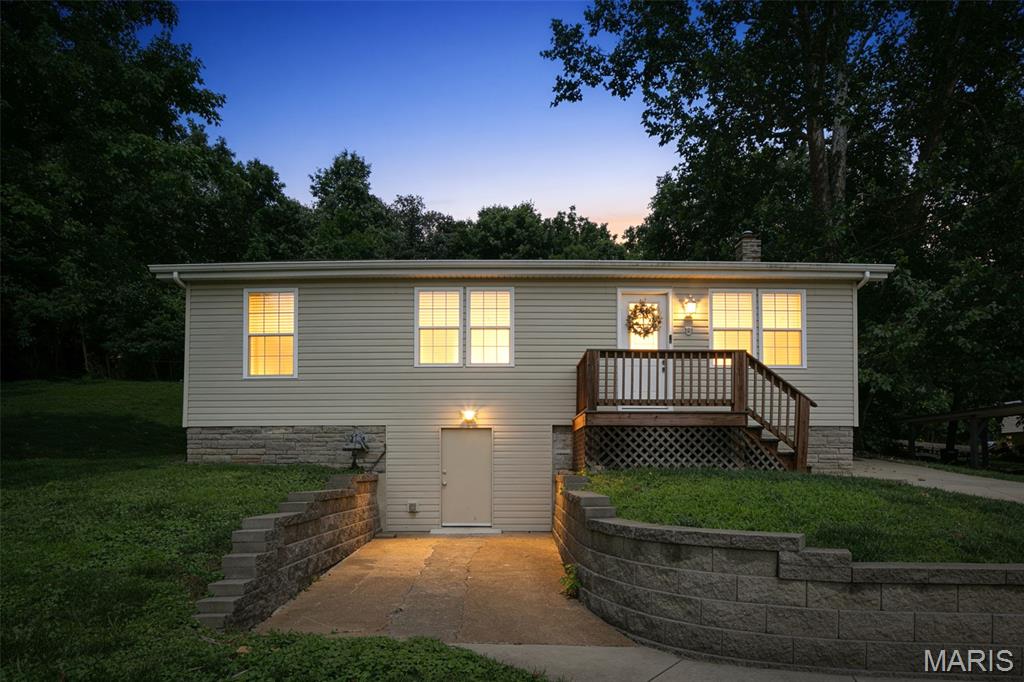 Charming and well-maintained home featuring 3 comfortable bedrooms, an updated kitchen and bath with a spacious main-floor laundry/utility room. The kitchen offers stainless steel appliances, including a new refrigerator and stove. The washer and dryer stay. Additional highlights include thermal tilt-in windows, 2 panel interior doors, pantry, wire racks in closets, tile and laminate wood flooring. Several major updates: Roof (2023), Furnace (2023), Water Heater (2024). The walk-out basement provides generous storage space, and the private rear patio backs to peaceful woods. Nice stone landscaped walls front and back. Fresh paint, newer flooring, and thoughtful improvements throughout make this home truly move-in ready.
