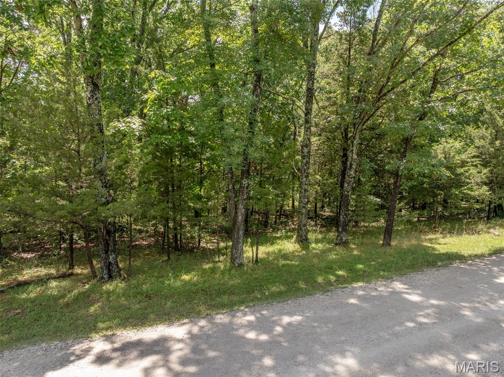 If you’ve been searching for the perfect place to build your getaway chalet in the woods this 1.75-acre lot at Innsbrook deserves a look. Tucked among a beautiful mix of mature Missouri hardwoods, the gently sloping terrain offers exceptional privacy, natural beauty, and an ideal setting for your future chalet. Picture mornings on the deck surrounded by towering trees, cool summer shade, and brilliant fall colors in every direction. A scenic community hiking trail borders the back of the property, offering easy access to peaceful walks. Spend your days enjoying the nearby beach at Kitzbuhl Lake or take advantage of quick access to Lake Alpine for boating, fishing, and recreation. With generous space between neighboring properties and convenient access to many of Innsbrook’s premier amenities! Please note that all chalet construction is done through the Innsbrook's construction department. Building guidelines and restrictions apply. Opportunities like this are becoming harder to find—secure your own piece of resort-style living today.