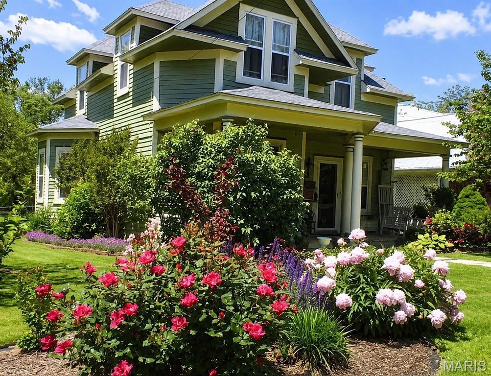 Historic German Victorian home currently operating as a successful Airbnb with proven short-term rental income history! Offered fully furnished, this unique property is ready for continued short-term rental income, or the perfect home for a growing family. Inside you'll find stunning craftsmanship throughout, including a show stopping staircase and a gorgeous stained-glass front door that welcomes you with historic character. Large windows fill the home with natural lighting, creating bright and inviting living spaces. The spacious dining room is ideal for hosting family gatherings or entertaining guests, while the cozy living room features a fireplace that adds warmth and charm. This home offers 3 bedrooms (including 1 non-conforming bedroom), and a relaxing primary suite with a spa-like atmosphere that is complete with a classic clawfoot tub. 

Outside, enjoy a spacious patio with ample seating, a large backyard with a dedicated garden area, and a substantial playhouse that could also serve as a workshop, studio or hobby space. Situated on a desirable corner lot, the property backs to the city park, providing convenient access to the swimming pool and outdoor recreation. Ideally located just minutes from the golf course and pickle ball courts, this property offers the perfect blend of small-town charm, recreation and convenience. 

Whether you're looking for a turnkey investment property, or a character-filled home with room to grow, this one of a kind Victorian is a must see. Roof will be replaced prior to closing.