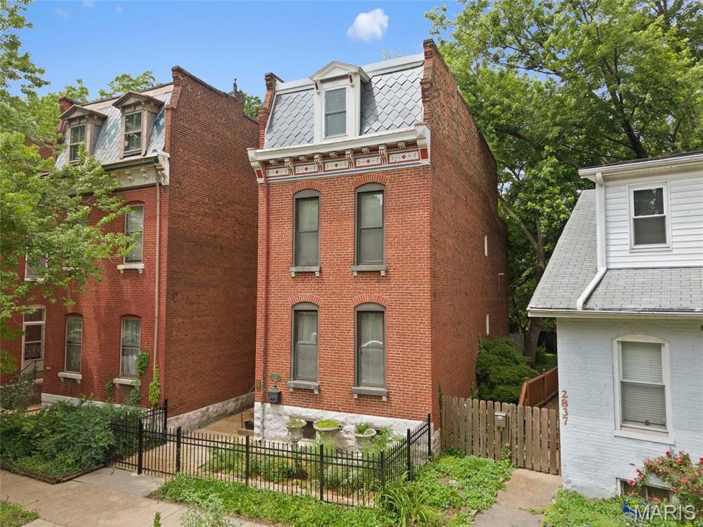 From the moment you arrive, this historic Benton Park showstopper captures your attention. Step inside to discover an updated three-story home that blends timeless character with modern style. The open living and dining rooms feature custom ceiling molding, historic millwork, and a convenient wet bar—ideal for entertaining.

The stunning 2020 kitchen impresses with floor-to-ceiling custom cabinetry, quartz countertops, a pot filler, and under-cabinet lighting. Throughout the home, enjoy gleaming hardwood floors, ceramic tile, fresh paint, and fully renovated baths with beautifully tiled showers.

The spacious, romantic primary suite includes a custom walk-in closet with a beautiful pocket wooden door. The newly renovated third floor adds two additional bedrooms and a full bath—perfect for guests, office space, or a private retreat. Upgraded window treatments throughout add a refined finishing touch.

Outside, the enchanting fenced backyard offers a serene space for relaxing or hosting gatherings. Secure, covered off-street parking with a garage door provides peace of mind and convenience. With local shops, businesses, and parks just steps away, this is city living at its finest. This stunning three-story historic Benton Park home is easy to show and ready for its next chapter!