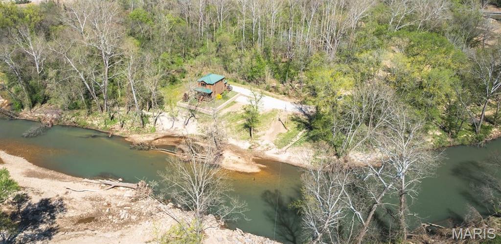 The Little Piney river never disappoints! Tight Lines Lodge is conveniently located just outside of Newburg, Missouri. Located about an hour and a half from St. Louis and Springfield and roughly 3 hours from Kansas City. This beautiful recreational retreat sits alongside the Piney with a meticulously built home. The property has been professionally landscaped with a large concrete retaining wall. Key features of the lodge are concrete hardboard siding, crosscut white pine trim and hard wood floors. The lodge has a great view of the river from the rear porch. World class fishing right in your back yard, just down river from white ribbon and blue ribbon trout areas where over 20 inch rainbow have been caught within site of the back porch. Great panfish and trophy small mouth fishing during the warmer months. The house comes nearly fully furnished as well.