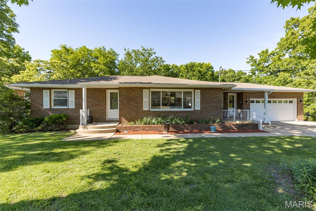 Stunning all-electric brick ranch in the Festus School District designed with entertaining in mind! Features a beautifully updated main level that sets the tone upon entry. Home showcases two brand new front entrances leading into the dining area and living room that includes keypad access. Enjoy your morning coffee or a relaxing evening from the spacious covered front porch or the generous sized 27x11 rear deck overlooking the tree-lined backyard. Open kitchen/dining features stainless steel appliances, touchless faucet, soft-close cabinetry, granite countertops, separate pantry, coffee bar featuring a pot filler, an oversized center island ideal for food prep, entertaining and additional seating, complete with deep pull-out drawers. Dining room offers convenient access to attached 2-car garage and rear deck. Open dining and living areas flow into the generously sized living room featuring an electric fireplace and abundant natural light. Primary bedroom includes half bath and walk-in closet. Main bath features stacked washer & dryer for convenient main-floor laundry. Thoughtfully renovated lower-level walkout features full kitchen with stainless steel appliances, family room, two bonus rooms (one with walk in closet), laundry room, full bath and flexible living space for guests, entertaining or extended living. Outdoor living is exceptional with a built-in pool already open and ready for summer enjoyment! Expansive concrete patio areas, and a covered lower patio created by upper deck, offering more entertainment space. Backyard offers wooded surroundings with no direct rear neighbors, creating a peaceful private setting. New retaining wall by second driveway adds both function and curb appeal. Heated & cooled full-length reinforced lower-level garage workshop/hobby space extends the depth of the 2-car garage great for equipment, recreational storage, or hobby use. Home includes updated 220-amp electric services. Additional highlights include modern bubble-style interior lighting and exterior lighting, LVP flooring throughout, LeafFilter gutter guards, electric water heater and updated HVAC system. The home has been extensively and meticulously renovated in recent years, offering a fresh, move-in-ready feel. No HOA! Conveniently located near schools, shopping, hospital, restaurants, and quick access to Hwy. 61/67 & 1-55. Don't miss this exceptional property!