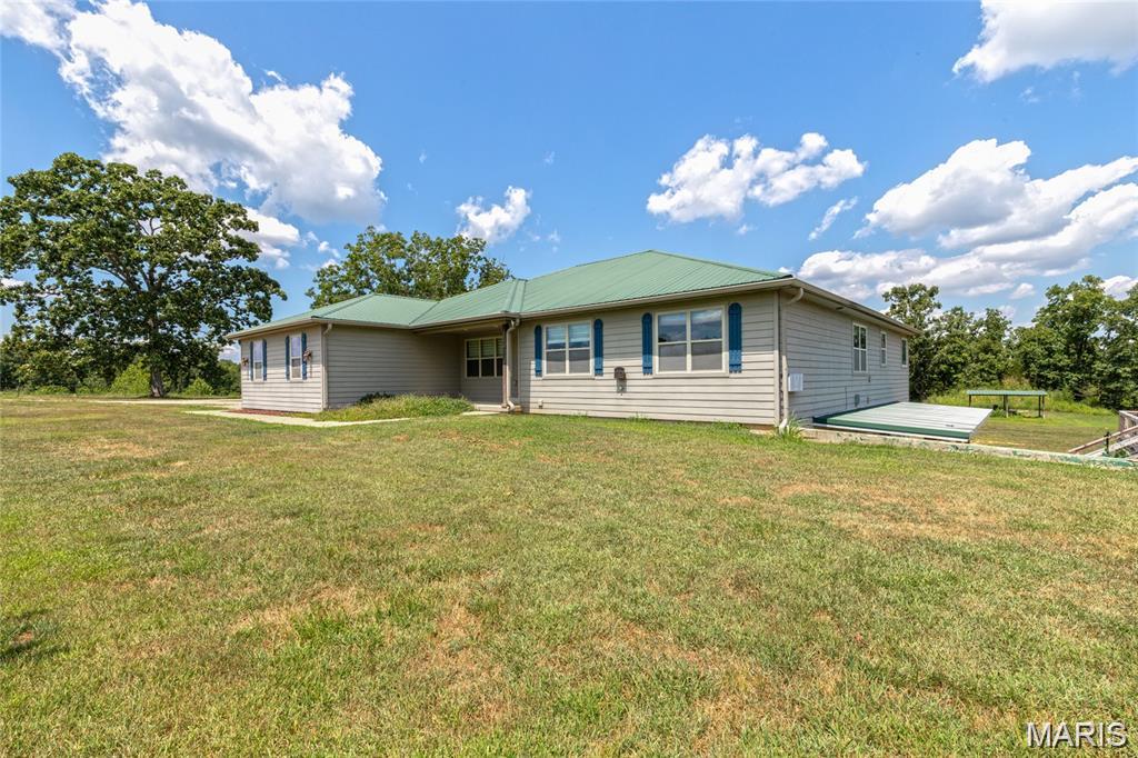 This is your "Chance of a Lifetime" to own THE Ultimate 50 Acre Missouri Cattle Ranch!! Nestled at the end of a quiet Country Road, this Working Cattle Ranch is turn-key and ready for you to bring/build your own Herd! As you drive through the Large, Arched Gate Entrance you will gaze upon the Crown Jewel to this Ranch ~ the Spacious 6 Bedroom Estate. Fully Loaded with an over-sized Gourmet Kitchen, with abundant Counter space, High-end appliances, HUGE Center Island with extra seating, expansive windows throughout for Amazing Panoramic views over the landscape, with beautiful Natural light flowing throughout. A curated Lifestyle, a perfectly calm-ambiance for growing Plants, Enjoying Nature, Relaxation & Gratitude. Savoring the views from your Kitchen Windows, you can Look out over your Livestock, & notice abundant Wildlife all around. The large Covered back-porch is perfect for sitting outside and and enjoying the breeze. This Home has it all! Walking downstairs you will find a wet-bar, Living Room, 2 full Bedrooms, Man-Cave w/ Walk in Gun-Safe and Armored Vault Door. A Basement door also leads out to the Outdoor Wood Furnace/Boiler for additional warmth in the Winter, Energy efficiency, and low Utilities. You can also Hop right into the Hot Tub and sooth those sore Muscles after a long day working the Ranch. Last but not least- A Large Barn for Livestock, Hay, Equipment Storage.