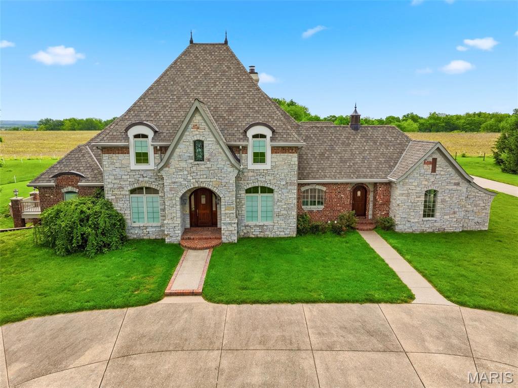 In my opinion THE BEST property in Elsberry w/ over 187 acres of sprawling land, A beautiful estate that offers luxury living at it's finest including elevator access on all 3 levels of the home. Beautiful views from every direction with fenced pastures and a large barn and large pond perfect for your horses. The long driveway flanked by trees is stunning, this property has been in the family for many years. Once in a lifetime opportunity to own this unique property that also Includes 3 underground limestone mines. The mines were excavated in the 1930’s. An impressive formation of Kimmswick Limestone, stone floors w/ up to 40' ceiling heights on the LL & stone pillars that are 50-60 feet apart. Boasting 440,000 SF of space, great location for temp. controlled storage, average temp. 53-58 degrees or a manf. warehouse. Also includes a 2nd lake that is two acres and filled w/ fish. Rail & river access nearby as well w/ gorgeous views. Perfect location for winery or resort w/ convenient access to Hwy 79 & approx. 25 minutes to HWY 70. There is also approximately 35 acres of crop land included in the lower river valley.