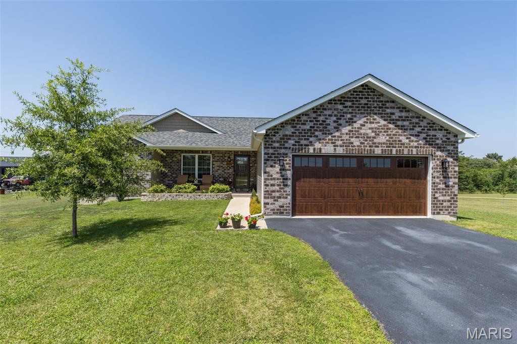 Built in 2022, this beautifully designed farmhouse-inspired home offers both style and comfortable living—all in the Central School District. If you've been dreaming of country living without the upkeep of a large acreage, this property offers the best of both worlds with a manageable, fenced yard just outside of town.
Step inside to an open, vaulted floor plan filled with natural light. The kitchen is the heart of the home, featuring a large island, quartz countertops, stainless steel appliances, the dining area has easy access to the back deck—perfect for grilling, entertaining, or enjoying peaceful evenings outdoors.
The main level offers three spacious bedrooms and two full baths, including a private primary suite with coffered ceiling, walk-in closet. The primary bath is complete with a soaking tub, separate shower, and double vanity.
The finished walkout lower level expands your living space with a large family room, full bath, and a versatile office or non-conforming sleeping area—ideal for guests, a home office, or hobby room. There's also plenty of unfinished storage space to keep everything organized.
With its modern farmhouse charm, functional floor plan, and location just outside the city limits, this home is perfect for buyers looking to enjoy a little more peace and privacy while still being just minutes from everyday conveniences. Don't miss this move-in ready opportunity!