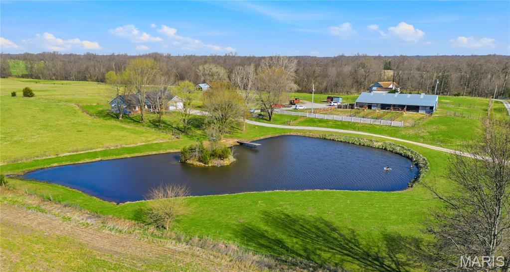 Mid Missouri 20 acre Horse Property! Opportunities like this don't come up very often! This well maintained and spacious 3 bedroom home (plus office) offers a unique blend of comfort and functionality, perfect for those seeking country living with convenience. Thoughtfully set up for equestrian living, this turnkey facility features 6 horse stalls with pens and runs, 15 acres of fenced pasture and 2 ponds that add beauty and practicality to the land. Located on blacktop for easy access to both I-70 and Hwy 54 this property provides the perfect balance of peaceful rural living while still being conveniently close to nearby cities. Whether you're looking for equestrian property, room for cattle, or simply room to spread out, this is a rare find you won't want to miss.