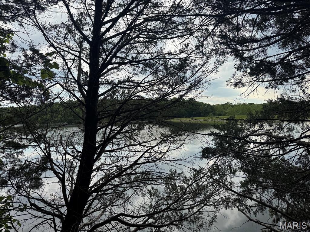 Approx. 3 acre lakefront lots.Own a piece of History with this historic home privately nestled in Fawn Lake Subdivision. Enjoy your own lake front lots totaling approx. 3 acres and all the amenities of this lake community that includes a beach front, swimming, fishing, plagrounds and a pavillion for your entertaining needs. There are a total of 8 lots and 5 Tax ID numbers included in the sale. Six of the lots face the lake and the historic home is on 2 lots across the road. There is a summer kitchen included with the sale that would be perfect for any artist or craftsman. The historic Hand-hewn timber log barn has construction similar to the sleeping lodges at the Dana Brown Overnight Ed. Center in Shaw Nature Reserve. Seller will not divide house and lots. Tax IDs included in the sale are 016000,072000,018000,019000,017000. Lots included in sale are lots 1, 2 that the house is on and lots 5-10 that are mostly lakefront. Seller to sell property as is. No drive bys. Must have confirmed appointment to show.