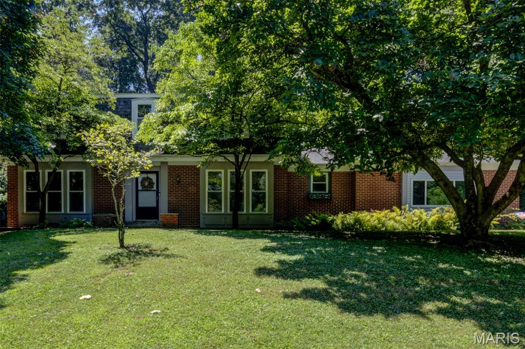 Open House Sun., 7/19, 2-4 PM. Nestled on a breathtaking 1.314-acre million-dollar lot, this private wooded estate offers an extraordinary blend of nature, serenity, and convenience. Wake each day inspired by God's magnificent creation, with picturesque views in every direction and abundant wildlife right outside your door. A welcoming brick patio and long private driveway create a memorable arrival, while the peaceful setting feels worlds away—yet you're just minutes from major roads, highways, shopping and restaurants. The subdivision pool & playground are conveniently located just across the street. This spacious two-story home offers 2,444 sq. ft. above grade with 5 bedrooms, including a main-level bedroom and 3 full baths. Designed for flexibility, the home features two primary suites—one on the main level and another upstairs—each with an adjoining full bath, making it ideal for multigenerational living, guests, or a private home office. Built for lasting value, the exterior showcases low-maintenance brick on three sides with vinyl siding, an oversized side-entry garage, updated garage door plus roof and gutters (2017), thermal windows, upgraded sliding patio door and a 2024 electrical panel. Inside, you'll find beautiful wood floors, skylights, neutral decor, a cozy wood-burning fireplace, white six-panel doors, central vacuum, attic fan, security system, generous closet space, select bath updates  plus added attic insulation and ridge guard on roof for improved efficiency. This is a rare opportunity to own an exceptional property where natural beauty and everyday comfort come together in high-rated Parkway Central School Distrct. Home located in the 100 year flood plain. Flood insurance required for loan.