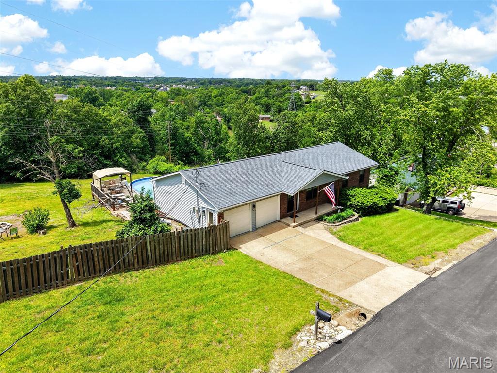 Welcome to this beautiful ranch homestead offering space, flexibility and features you simply won’t find in a typical subdivision! Hilltop living on nearly an acre with incredible views, a three-tier deck and a partially finished walkout lower level. This three bed, three bath ranch offers an oversized two-car garage with extra storage or workshop space, fenced yard and updates throughout. Enjoy a main-floor primary suite with deck access where you can enjoy breathtaking sunsets right from your bedroom. The lower level features a second full kitchen, flexible living space and its own electrical panel, ideal for entertaining or flexible living.
 
Outdoor living shines with a large backyard, fire pit, hot tub and an above-ground pool with a wrap-around deck. The pool pump was replaced in 2021, giving peace of mind for seasons to come. The fenced yard offers space for pets, play or gardening.
 
Both refrigerators, washer/dryer, pool furniture, pool chemicals, BBQ grills, and riding lawn mower can stay with home. This home offers freedom and flexibility, with the convenience of being minutes from shopping, highways, and the award-winning Fox School District.
 
Major updates: newer roof and siding (2025), newer furnace and AC (2022) and newer pool liner (2021).