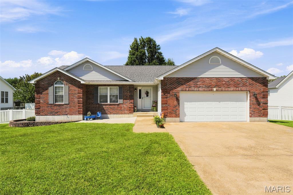 Welcome home to this well-maintained one-story ranch, built in 2003, offering easy, single-level living close to major roads and shopping. Vaulted ceilings and hardwood flooring add character throughout the main living areas. This 3-bedroom home features a primary suite with a full bath and walk-in closet, plus two additional bedrooms and a hall bath, all conveniently located at one end of the home. Main floor laundry is conveniently located off the kitchen, which offers a center island with breakfast bar seating, pantry, and a built-in desk nook.

Step out from the living room onto a the 15 x12 private deck, with a patio below - perfect for relaxing or entertaining. The full basement is partially finished with a walkout to the patio, offering valuable bonus space with room to grow into as your needs change.

Outside, the fully fenced backyard features vinyl privacy fencing with gates on both sides of the home, mature trees, and a 2-car garage paired with an oversized driveway for extra parking.

Additional peace of mind comes with a brand-new roof (installed June 2026), and this all-electric home offers simplified utility management.

Move-in ready and in a fantastic location - schedule your private showing today!