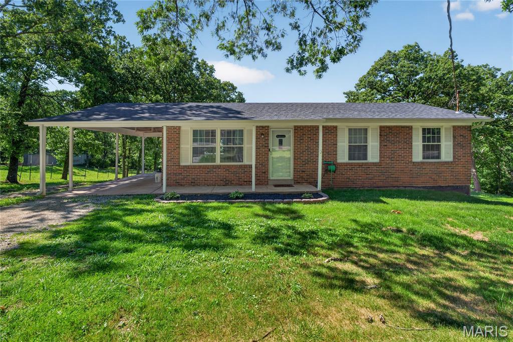 HILLSBORO SCHOOLS - Enjoy peaceful country living in this beautifully maintained ranch on 2 acres +/-, offering privacy while staying close to town. The main level features spacious bedrooms with large walk-in closets, 1.5 updated bathrooms, and comfortable living areas designed for everyday life. The kitchen is thoughtfully updated with solid surface countertops, a continuous backsplash, stainless steel appliances, and a butcher block island—perfect for cooking and entertaining. Step out onto the expansive, low-maintenance composite deck to relax and enjoy the outdoors. The finished walkout basement adds flexibility with two additional rooms, a bedroom, office or play space, a cozy sitting area with a wood-burning fireplace, and a dedicated workshop with walkout access to a fire pit area. Outside, the oversized yard provides plenty of space for outdoor activities, and the backyard outbuilding offers convenient storage for tools and equipment. This rare combination of space, privacy, and convenience makes this home ready for you to enjoy.  HILLSBORO SCHOOLS Newer Roof water heater, deck - see seller disclosures for additional details.