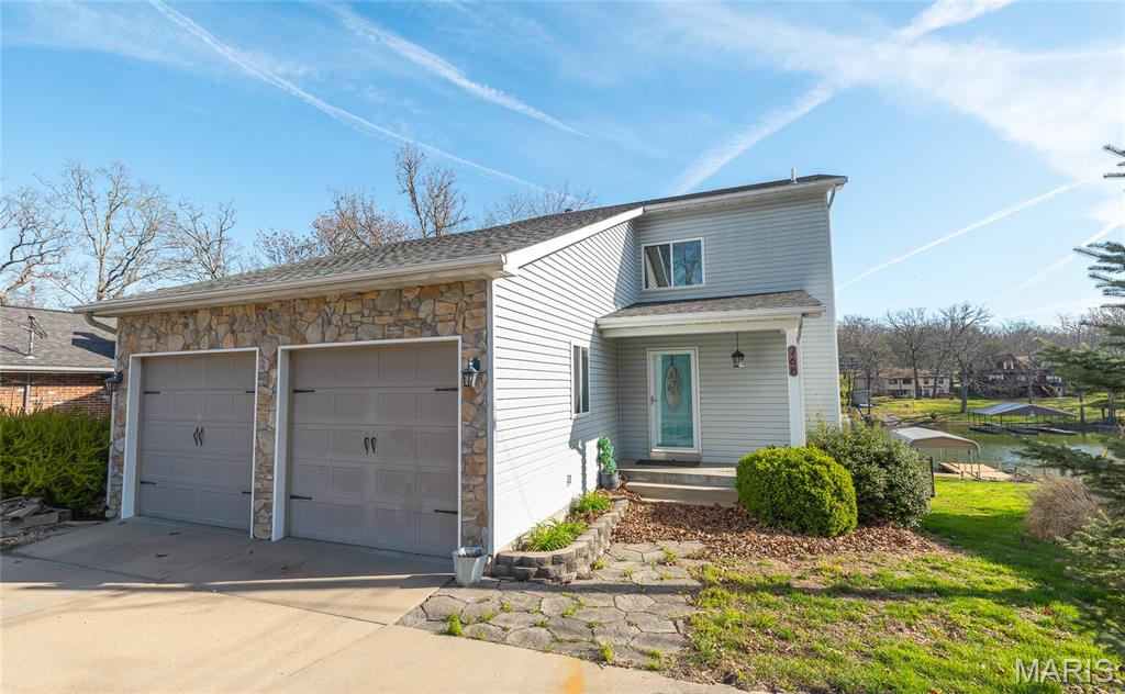 Beautifully updated and meticulously maintained lakefront home with stunning water views and exceptional living space. The main level features a bedroom, full bath, laundry and an updated kitchen with granite countertops and stainless steel appliances. The rear of the home is the showstopper, with soaring ceilings, a gas fireplace and a wall of windows that fill the living room and sunroom with natural light and breathtaking lake views. The entire second floor is a spacious primary suite with a large bedroom, en suite bath and walk-in closet with room to expand for additional bedrooms. The finished walkout lower level offers a full bath, kitchenette, wood-burning fireplace and flexible sleeping space, with the option to reframe a third bedroom. Enjoy the expanded dock, fully fenced backyard and oversized 2 car garage. Most furniture (purchased in 2023) and the boat are negotiable. All-electric home with updated roof and systems.