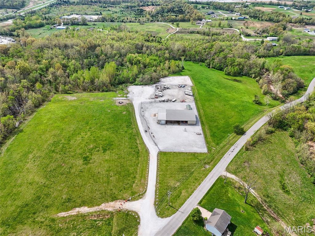 Outstanding opportunity to own your own shop, storage facility or future development!  The property has so much potential! This 25+/- acres of ground has all city utilities and over 9,000 sq ft under roof! The main building is 9,000 sq ft and there is a secondary, smaller building as well.  Some of the large shop is enclosed and heated and insulated with a bathroom and some office space and some of the shop is open drive-through. There is a security fence with a rolling, automatic gate with keypad. Lots of space to park your vehicles or top store someone else's!  There is a large amount of unused ground for expansion. The possibilities are endless... use it for your own business or lease it out to another.  Develop it into outdoor storage or enclosed storage... either way, this property is a money maker and perfect for the 1031 exchange buyer!  Shcedule your private tour today! Location: Industrial Area, Other. Duplicate MLS#26002830