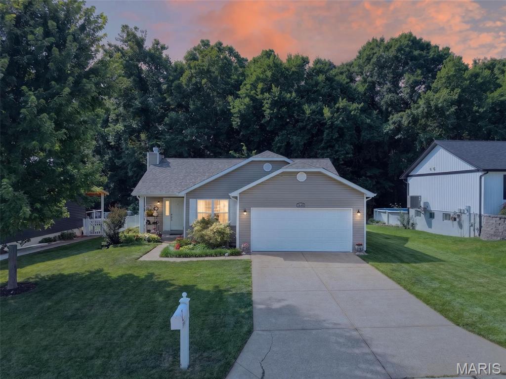 Beautiful ranch home featuring hardwood flooring throughout the entire main level and an inviting open floor plan designed for comfortable everyday living and effortless entertaining. The spacious living room with a wood-burning fireplace flows seamlessly into the dining area and beautifully updated kitchen. The kitchen showcases tasteful cabinetry, stainless steel appliances, solid surface countertops, and custom tile backsplash.
The generously sized primary suite offers a walk-in closet and private full bath. Two additional bedrooms provide ample space, while the hall bath has been tastefully updated.
The finished lower level expands the living space with a large recreation room, a versatile bonus room with a closet, a convenient half bath, and additional flex space ideal for a fitness area, home office, hobby room, or playroom. The laundry area is bright and functional, featuring  storage and countertop workspace.
Step outside to enjoy the beautifully landscaped backyard from the deck or patio overlooking the beautifully landscaped yard. Mature trees and lush greenery create a peaceful, private setting, while the gentle, quiet creek along the rear of the property adds a unique natural backdrop that the current owner has fond memories of enjoying and exploring over the years.
With a 1-year-old roof, a 5-year-old HVAC system, and thoughtful updates throughout, this move-in ready home offers the perfect blend of comfort, style, and functionality. A truly special property that is ready for its next chapter.