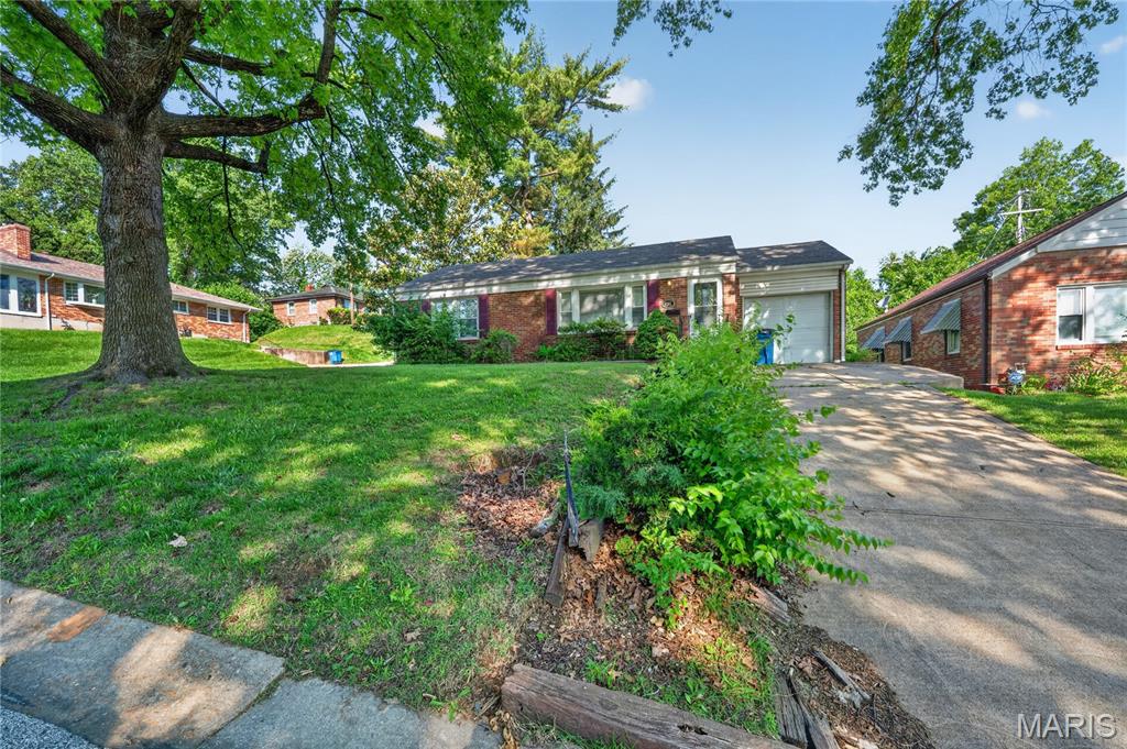 Welcome to this charming residential retreat located in the heart of the Northwoods area. This well-maintained home offers a perfect blend of comfort and convenience, featuring a classic architectural style that fits seamlessly into this established St. Louis neighborhood. The exterior boasts a paved driveway leading to a functional attached garage, ensuring easy access and off-street parking. Inside, the layout is designed to maximize space and natural light, providing a warm atmosphere for both daily living and entertaining. Situated on a level lot with professional curbing and gutters, the property offers great curb appeal and a low-maintenance lifestyle. Whether you are a first-time buyer or looking to expand your portfolio, this home provides a solid opportunity in a central location.