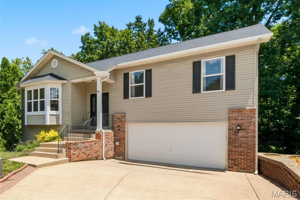 Nestled on a quiet cul-de-sac, this well-maintained, move-in ready 4-bedroom, 3-bath split foyer offers a functional layout and a private wooded backdrop in the heart of Lake St. Louis. The vaulted great room features a floor-to-ceiling brick fireplace, bay window, and abundant natural light. The kitchen offers a center island, stainless steel appliances, ample cabinetry, and an adjoining dining area.

The main level includes a private primary suite with full bath, plus two additional bedrooms and a second full bath. The finished lower level provides a spacious rec room, fourth bedroom or office, and a third full bath.

Relax on the deck overlooking mature trees and a peaceful creek. Enjoy Lake St. Louis amenities including lake rights, clubhouse, pool, golf, tennis courts, parks, and more. Conveniently located near shopping, dining, major highways, and within the highly rated Wentzville School District.
