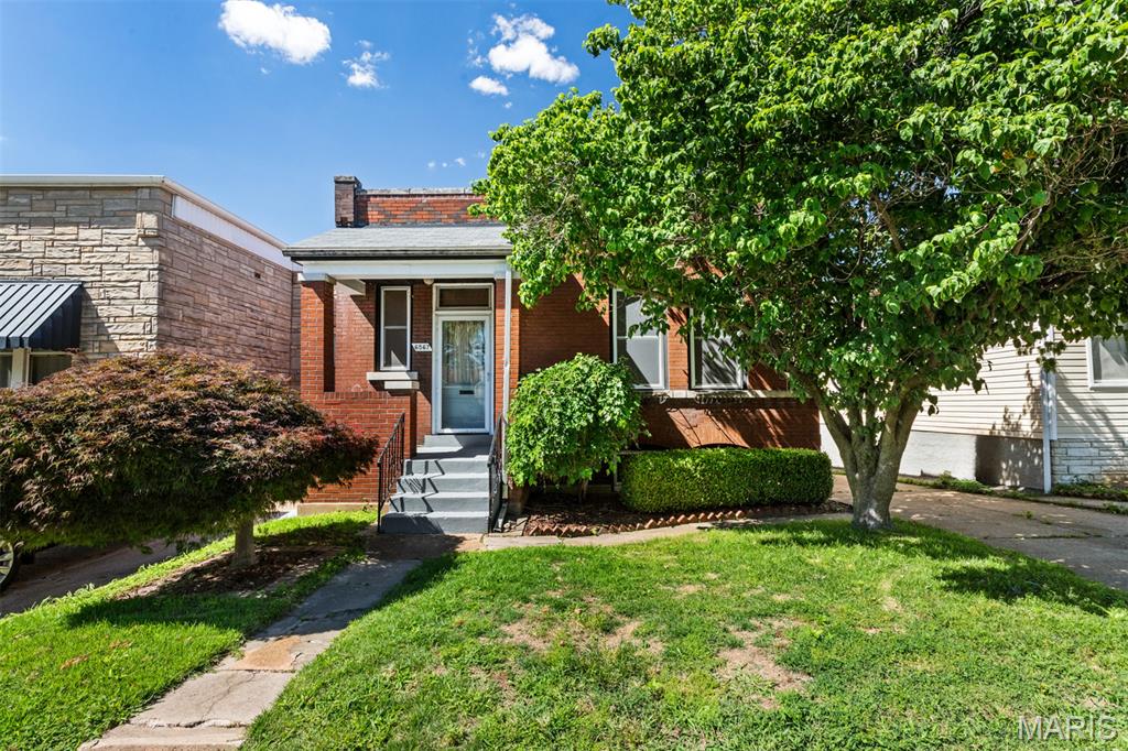 Rare opportunity in Lindenwood Park: 6567 Fyler Ave is a charming historic brick bungalow with an income-producing ADU (Accessory Dwelling Unit), perfect for an owner-occupant who wants to offset their mortgage or an investor expanding a portfolio. The main house features gorgeous hardwood floors, high ceilings, original millwork, a welcoming entry foyer, formal living room, two bedrooms with ample closet space, darling vintage bathroom, and a spacious kitchen that walks out to a covered deck. Recent updates include a new roof (2023) and new electric panel (2025). The basement offers laundry, a roughed-in bathroom area, and a separate room ideal for a home office. Outside, the property includes off-street driveway parking, a large fully fenced yard, and a detached garage/storage structure that could be converted to a working garage if the driveway is extended. Beyond the garage is the ADU with a long-term tenant currently paying $500/month, providing immediate rental income. Lindenwood Park is lovely - walkable to bars, restaurants, and the park itself—this is a rare find in one of South City’s most desirable neighborhoods.