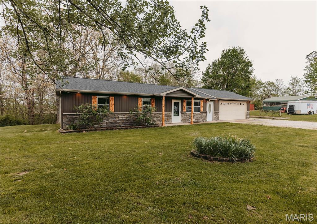 This well-maintained home has been loved and cared for over the years. Its sharp curb appeal will catch buyers’ attention, but the warmth and charm inside are what will make them want to stay. The family room features French doors leading to the back deck, where wooded views create a peaceful setting filled with wildlife and nature. Just off the dining area, the cozy kitchen is centrally located between the family room and living room, making it ideal for both entertaining and everyday comfort. The traditional floor plan offers three bedrooms and one bath tucked down the hall, providing privacy away from the main living spaces. Outside, you may find yourself enjoying the garden area and blackberries in the spring and summer, or relaxing out back while listening and watching for wildlife. Either way, the convenient location is a major draw. Additional features include a mudroom off the garage that could serve as flexible multipurpose space. Close to town, yet offering a country feel, and a nice-sized yard with a metal shed behind the garage. For added peace of mind, the roof was replaced in 2024, along with the siding, gutters, interior doors, fresh paint, and more. Other notable updates include family room addition, deck, mud room, kitchen appliances within the past couple of years, bathroom vanity and fixtures, updated lighting, carpeting, surround sound wiring in the main living room, updated garage lighting, and a storm door at the front entrance. If you are looking in the county, just outside of town with many updates, this may be the one!