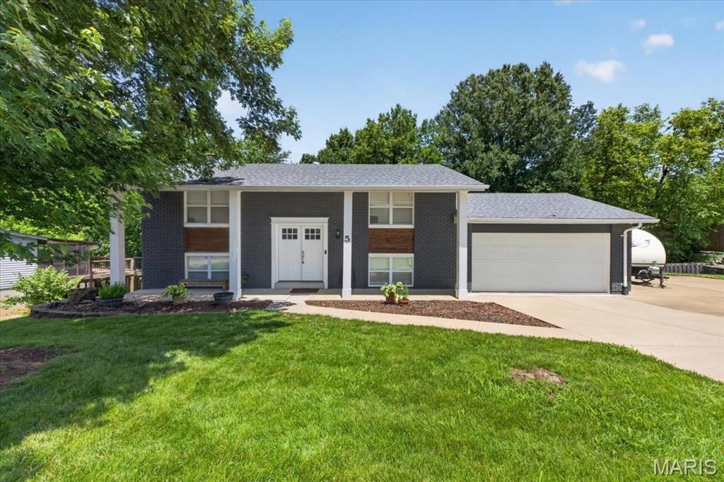 Welcome home to parkside living at its best! Tucked away on a quiet cul-de-sac street, this beautifully updated 4-bedroom, 2-bath multi-level home offers the perfect blend of privacy, recreation, lifestyle, and convenience. Backing directly to the scenic grounds of Twin Oaks Park, with a walking path just steps away, you'll enjoy easy access to trails, tennis courts, lakes, playground, and endless opportunities for year-round outdoor enjoyment. Enjoy your morning coffee or evening gatherings on the expansive composite deck overlooking the park behind the home. With mature trees providing a natural backdrop, this outdoor space provides a peaceful retreat and front-row seats to one of the area's most spectacular Fourth of July fireworks displays. Inside, the open-concept floor plan is designed for today's lifestyle, featuring an updated kitchen with a center island, shaker-style cabinets, stainless steel appliances, granite counters, pantry, and seamless flow into the main dining/living area. The lower-level family room is anchored by a cozy fireplace, creating the perfect space to unwind or entertain. The oversized 500+ square foot garage and extra-wide driveway provide abundant parking and storage for multiple vehicles, recreational equipment, boats, campers, and guests. Numerous features also include newer roof and windows. Ideally located just minutes from major highways, shopping, dining, and everyday conveniences. Rarely does a home offer such a matchless combination of park-side living, outstanding outdoor space, move-in ready condition, and an unbeatable location.