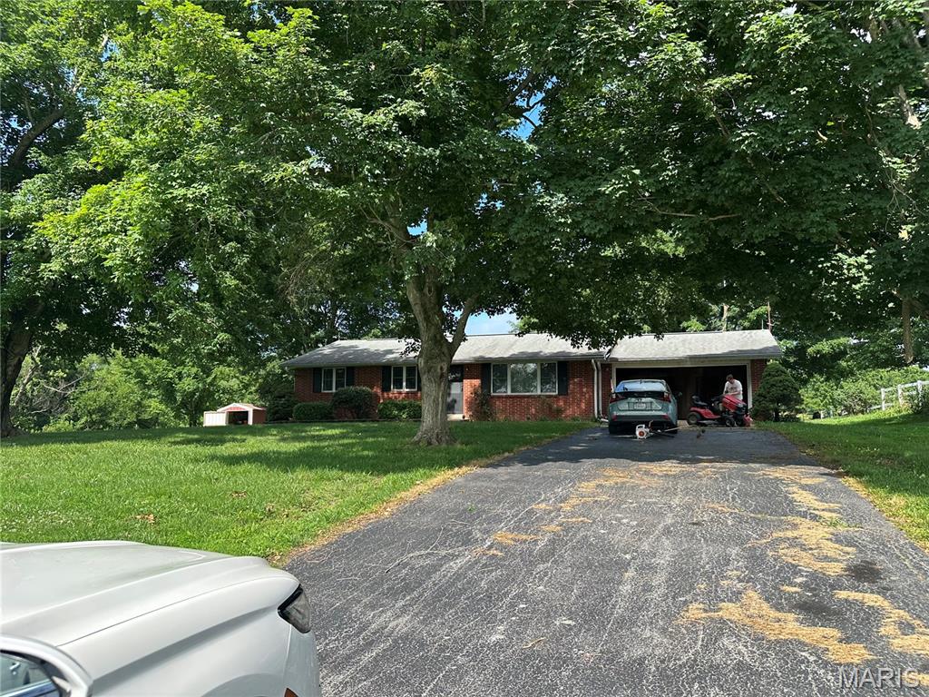 Enjoy the peace and privacy of country living with the convenience of being just minutes from Cape Girardeau, Jackson, and I-55. Situated on approximately 4 acres, this one-owner, 3-bedroom, 1.5-bath home offers a rare opportunity to create your dream property. Full of character and solidly built, the home is ready for your personal updates and finishing touches.  This property offers endless potential for those looking to make it their own while enjoying the beauty of a rural setting. Whether you're searching for a peaceful homestead or investment opportunity, this property is ready for its next chapter.  Home is being sold AS-IS.  There is hardwood floors throughout the living and bedrooms.  You can see it in the small hall closet.